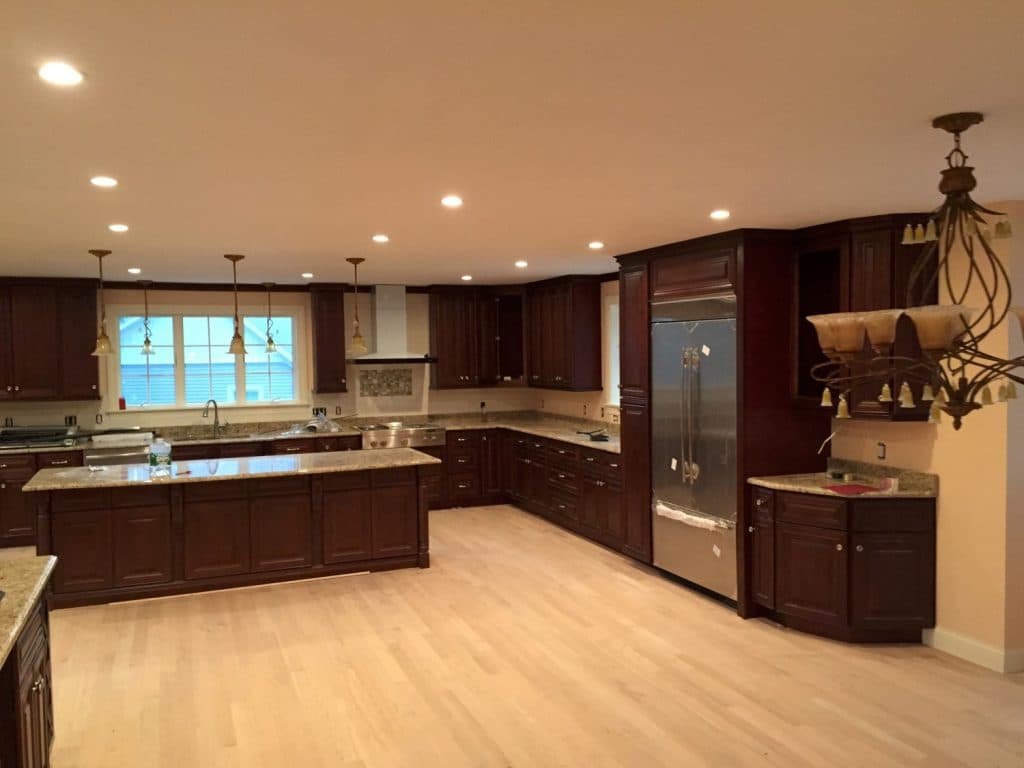 Kitchen with cherry cabinets and stone counters